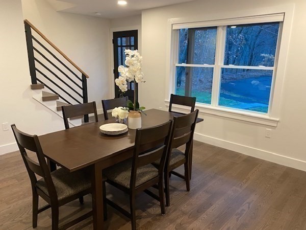 4 Wells Street Natick, MA 01760 - Photo 3 of 38 a view of a dining room with furniture and wooden floor
