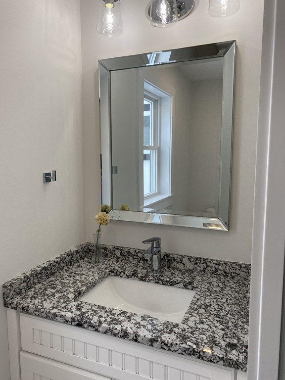 4 Wells Street Natick, MA 01760 - Photo 33 of 38 a bathroom with a bathtub and mirror