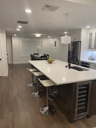 4 Wells Street Natick, MA 01760 - Photo 4 of 38 a kitchen with a table chairs sink and cabinets