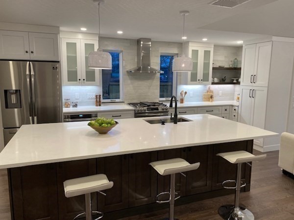 4 Wells Street Natick, MA 01760 - Photo 6 of 38 a kitchen with a table chairs sink and refrigerator
