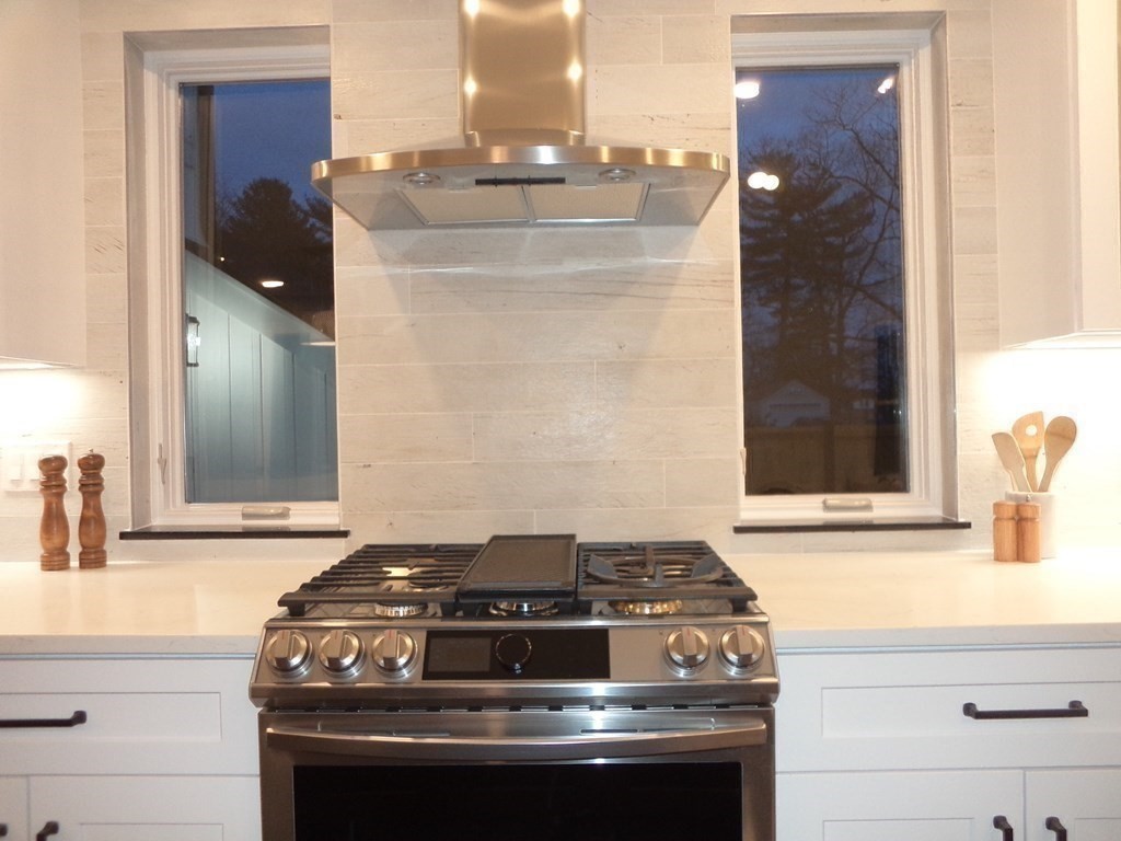 4 Wells Street Natick, MA 01760 - Photo 9 of 38 a stove top oven sitting inside of a kitchen
