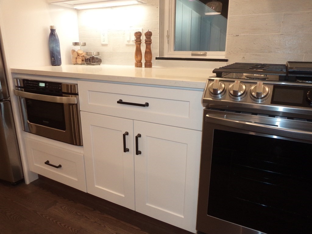 4 Wells Street Natick, MA 01760 - Photo 10 of 38 a kitchen with a stove and a microwave