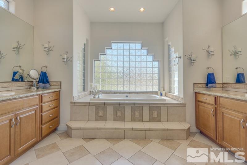 12670 Silver Wolf Road Reno, NV 89511 - Photo 17 of 25 a spacious bathroom with a tub sink and mirror