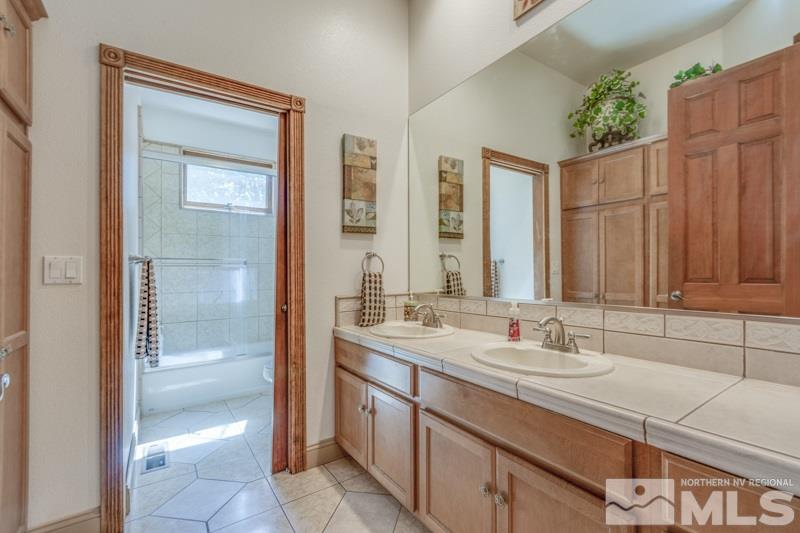 12670 Silver Wolf Road Reno, NV 89511 - Photo 20 of 25 a bathroom with a sink and a mirror