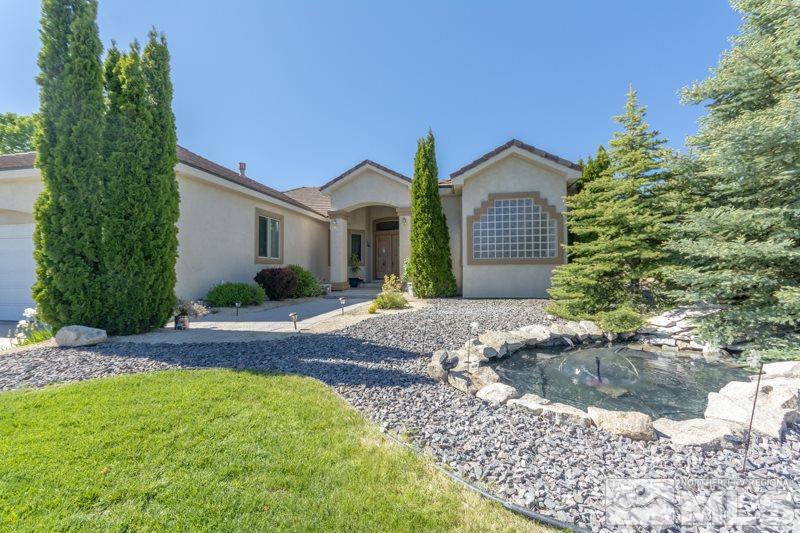 12670 Silver Wolf Road Reno, NV 89511 - Photo 2 of 25 a front view of a house with a yard and garage