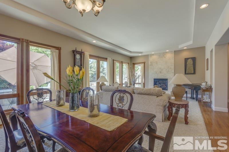 12670 Silver Wolf Road Reno, NV 89511 - Photo 8 of 25 a view of a dining room with furniture window and wooden floor