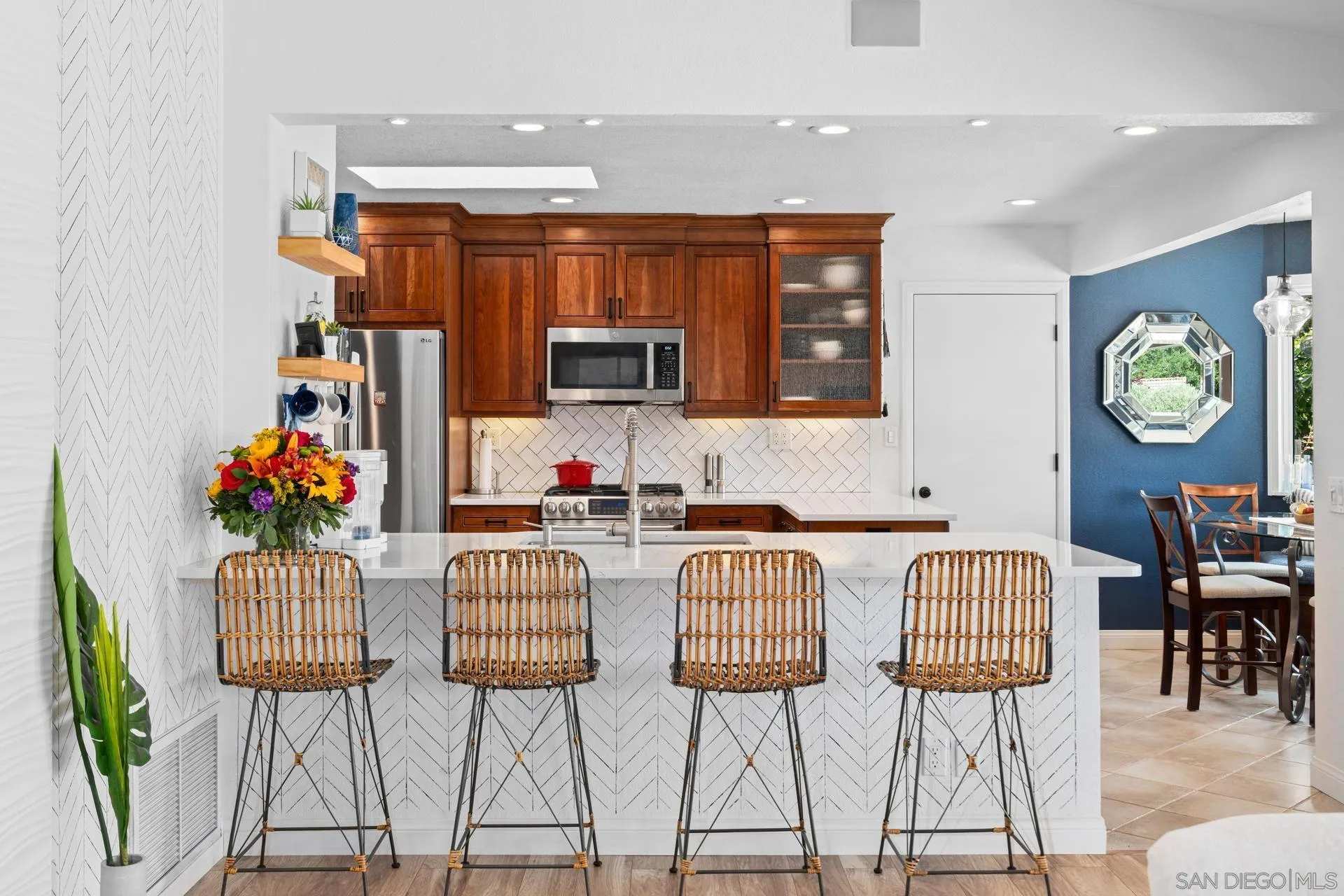 1009 Summit Trail Escondido, CA 92025 - Photo 11 of 59 a kitchen with stainless steel appliances kitchen island granite countertop a table and chairs in it
