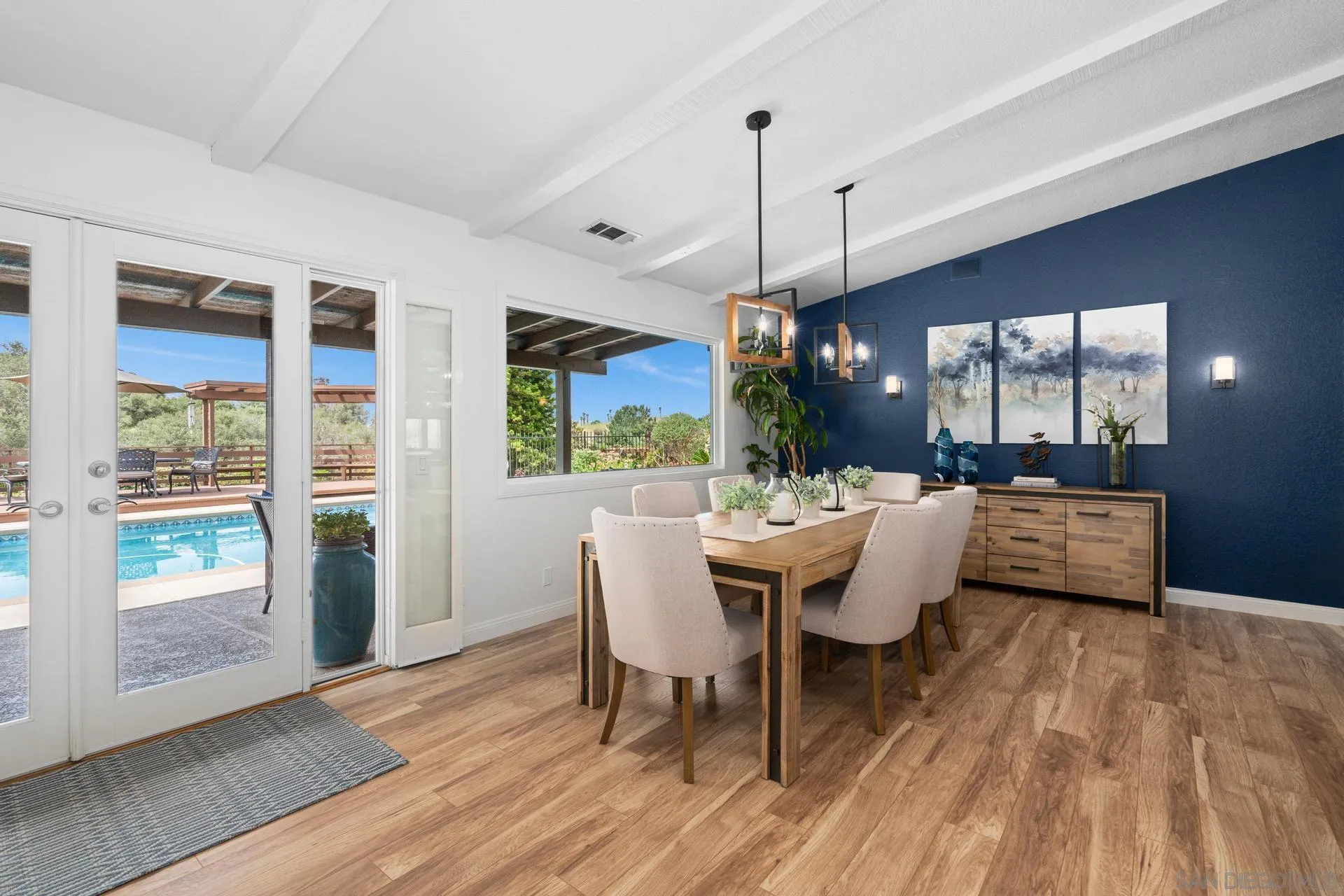 1009 Summit Trail Escondido, CA 92025 - Photo 15 of 59 a dining room with wooden floor a chandelier a wooden table and chairs