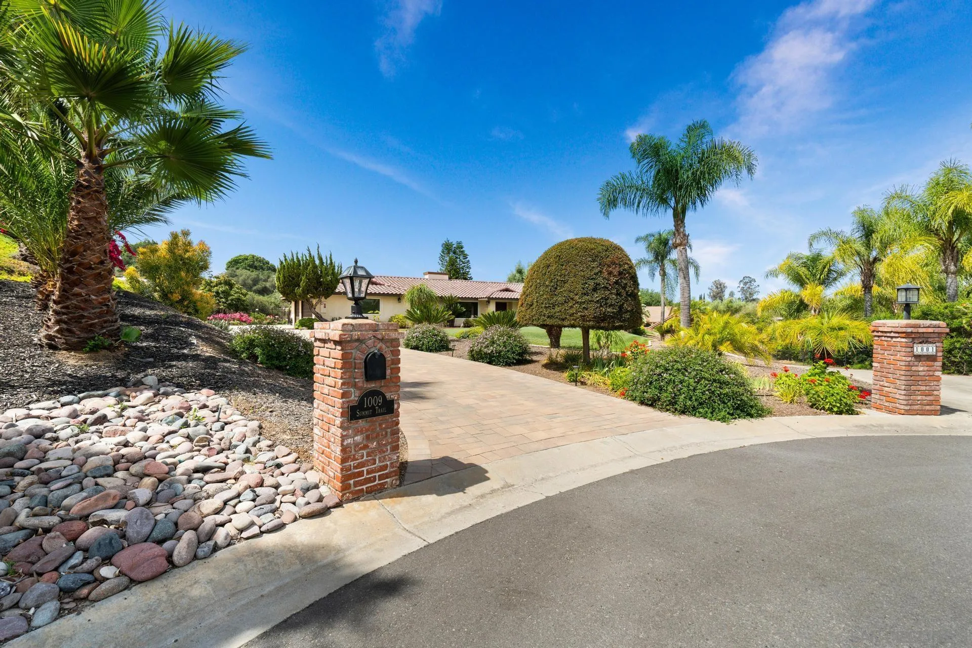 1009 Summit Trail Escondido, CA 92025 - Photo 35 of 59 a front view of a house with a yard and plant