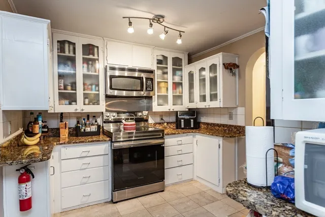 a kitchen with a stove oven and sink