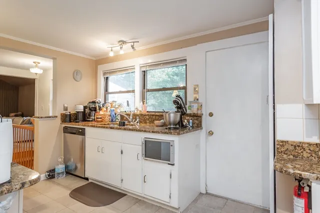 a kitchen with a sink cabinets and window