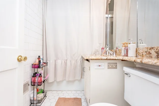 a bathroom with a sink vanity mirror and tub