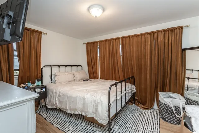 a bedroom with a bed and a window