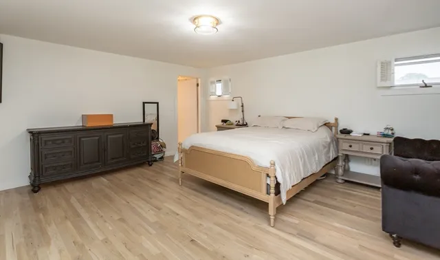 a bedroom with a bed and dresser