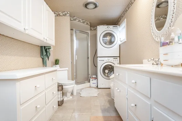 a bathroom with a sink a washer and dryer