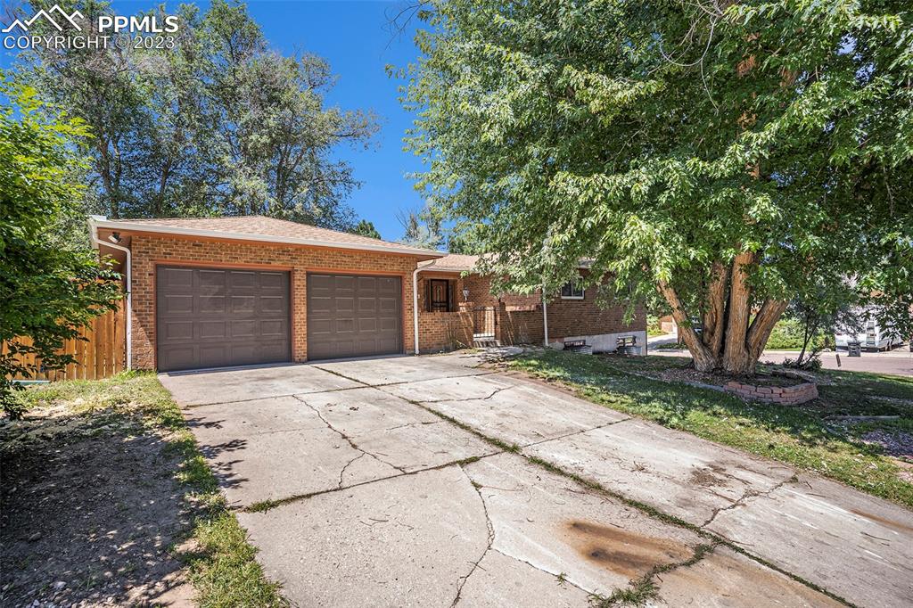 4506 Ridgecrest Drive Colorado Springs, CO 80918 - Photo 1 of 29 a front view of a house with a yard and garage