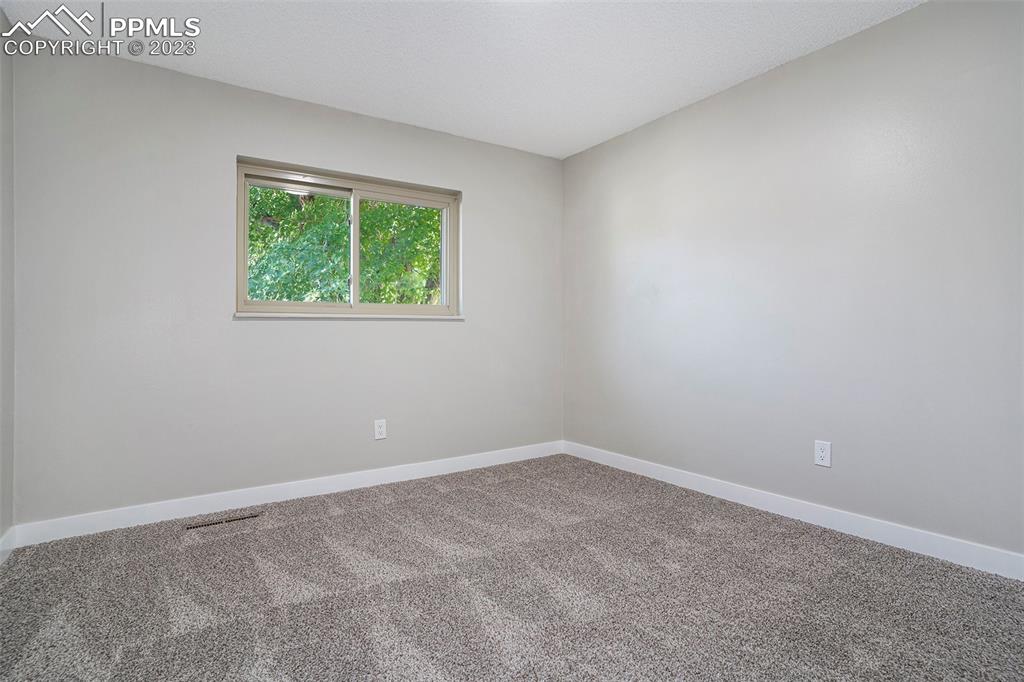 4506 Ridgecrest Drive Colorado Springs, CO 80918 - Photo 14 of 29 an empty room with a window