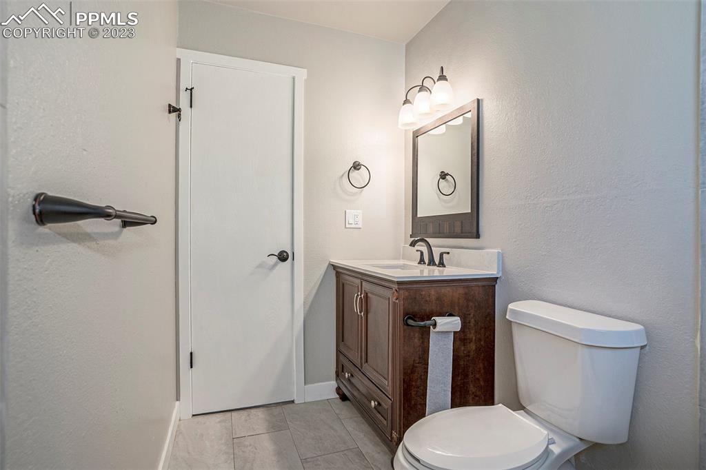 4506 Ridgecrest Drive Colorado Springs, CO 80918 - Photo 15 of 29 a bathroom with a toilet a sink and mirror