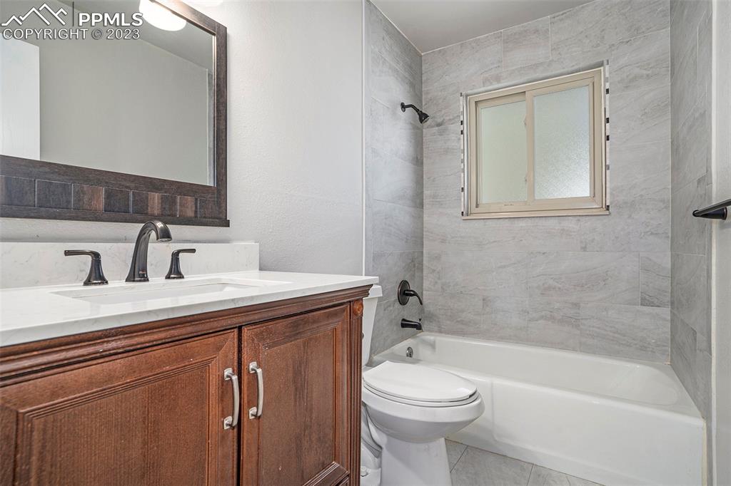 4506 Ridgecrest Drive Colorado Springs, CO 80918 - Photo 16 of 29 a bathroom with a sink a toilet and shower