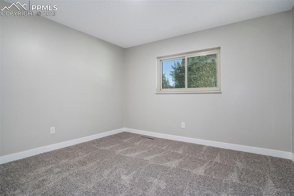 4506 Ridgecrest Drive Colorado Springs, CO 80918 - Photo 17 of 29 an empty room with a window