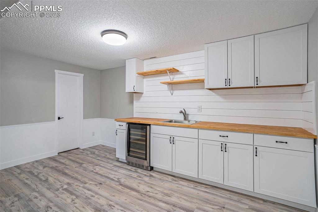 4506 Ridgecrest Drive Colorado Springs, CO 80918 - Photo 20 of 29 a kitchen with granite countertop white cabinets and sink