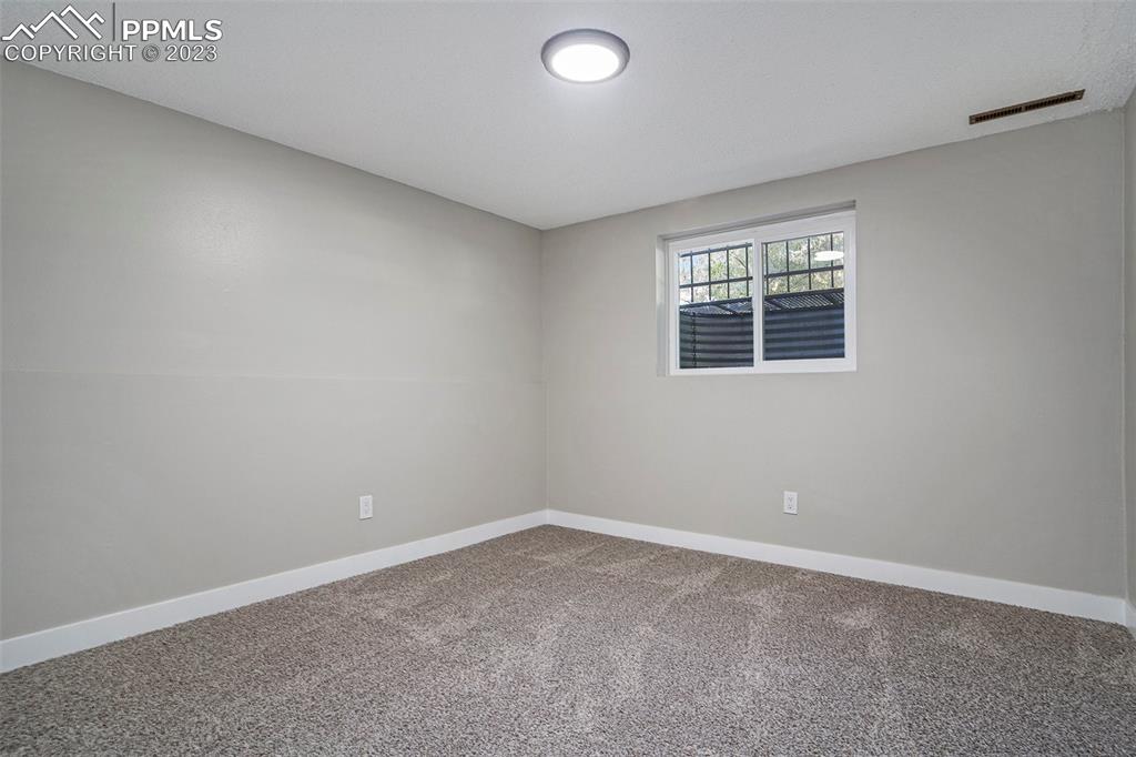 4506 Ridgecrest Drive Colorado Springs, CO 80918 - Photo 21 of 29 an empty room with a window