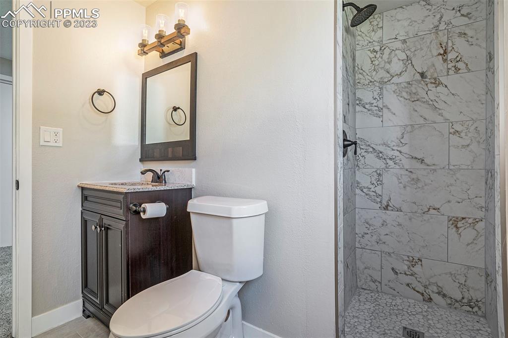 4506 Ridgecrest Drive Colorado Springs, CO 80918 - Photo 22 of 29 a bathroom with a toilet sink and mirror