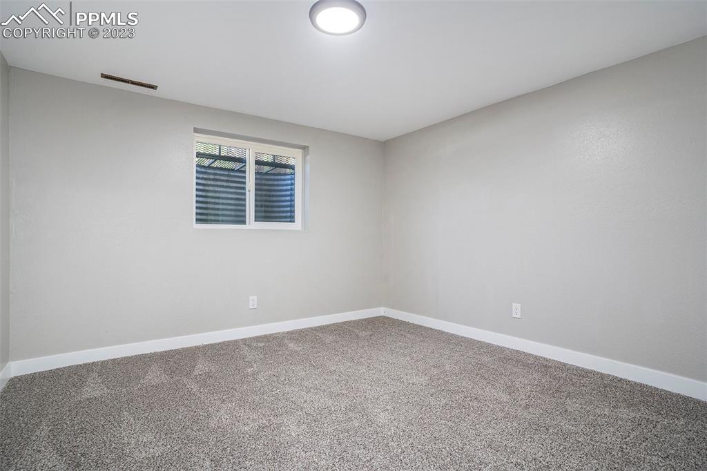 4506 Ridgecrest Drive Colorado Springs, CO 80918 - Photo 23 of 29 an empty room with a window