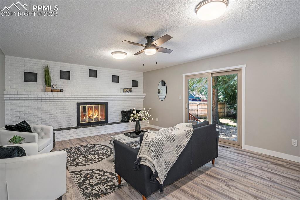 4506 Ridgecrest Drive Colorado Springs, CO 80918 - Photo 6 of 29 a living room with furniture and a fireplace