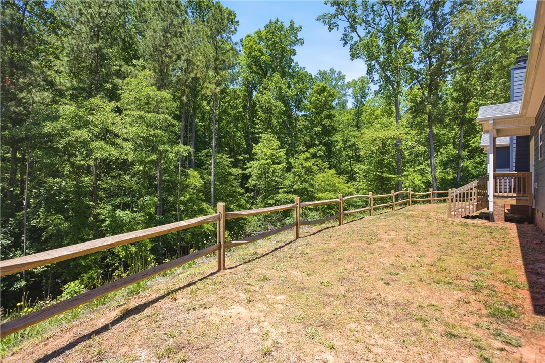 912 Watercrest Road West Union, SC 29696 - Photo 39 of 49 This tranquil yard features lush woodlands, a charming wooden fence, and a welcoming porch with steps.