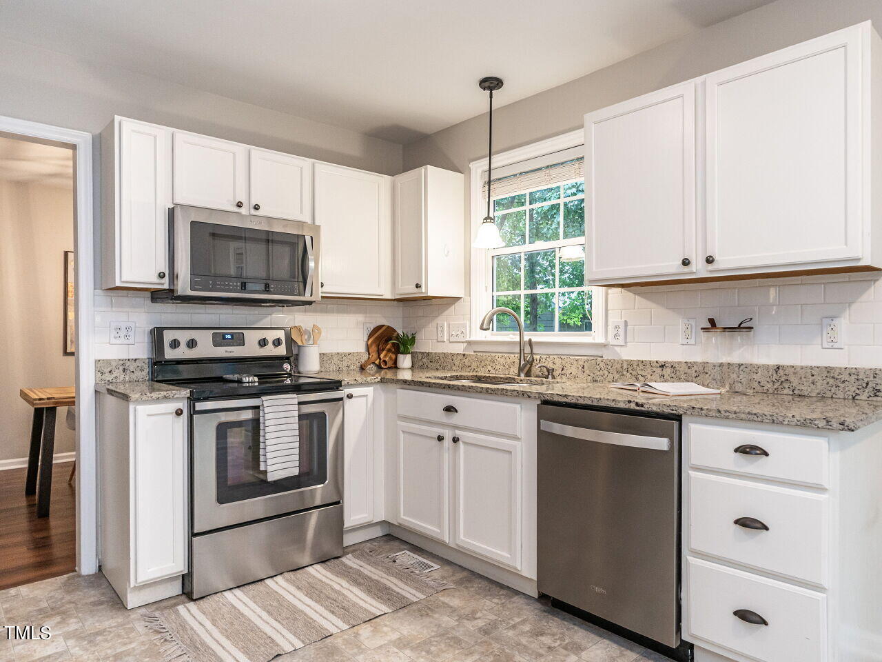 3 Madeira Court Durham, NC 27713 - Photo 11 of 27 a kitchen with granite countertop white cabinets white stainless steel appliances with a sink and a window