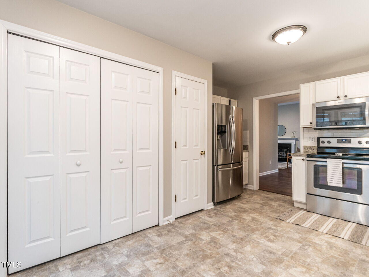 3 Madeira Court Durham, NC 27713 - Photo 13 of 27 a view of a kitchen with refrigerator and white cabinets