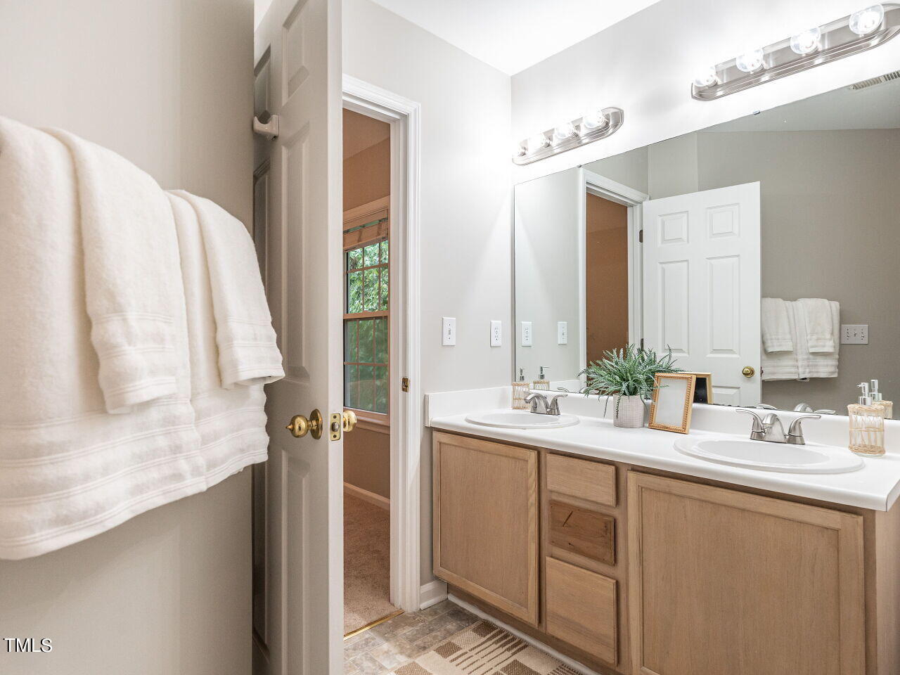 3 Madeira Court Durham, NC 27713 - Photo 18 of 27 a bathroom with a double vanity sink and mirror