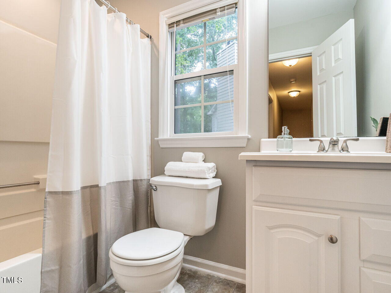 3 Madeira Court Durham, NC 27713 - Photo 20 of 27 a bathroom with a toilet a sink and a mirror
