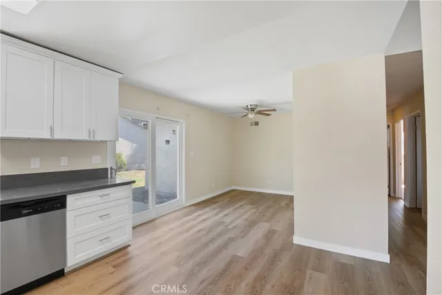 a kitchen with granite countertop a refrigerator and a stove top oven