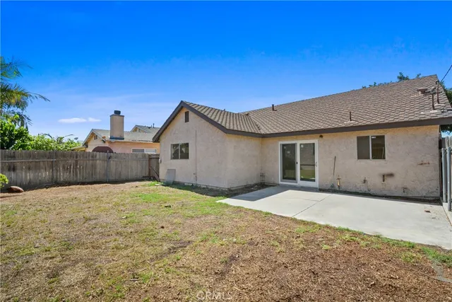 a backyard of a house with wooden fence