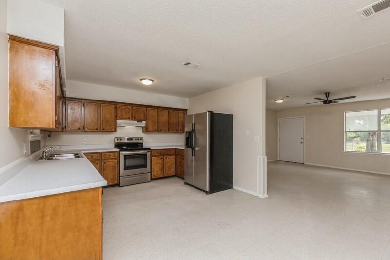 3369 Auburn Road Crestview, FL 32539 - Photo 12 of 33 a kitchen with stainless steel appliances a refrigerator sink and stove