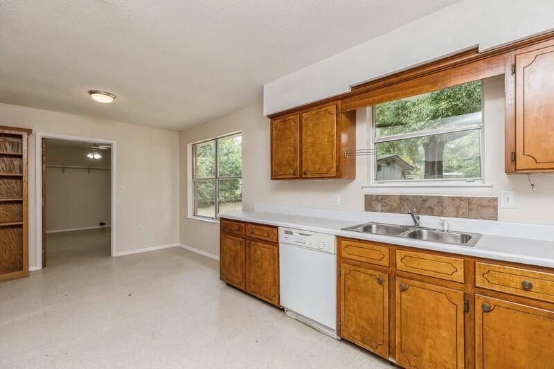 3369 Auburn Road Crestview, FL 32539 - Photo 14 of 33 a kitchen a sink a window and cabinets