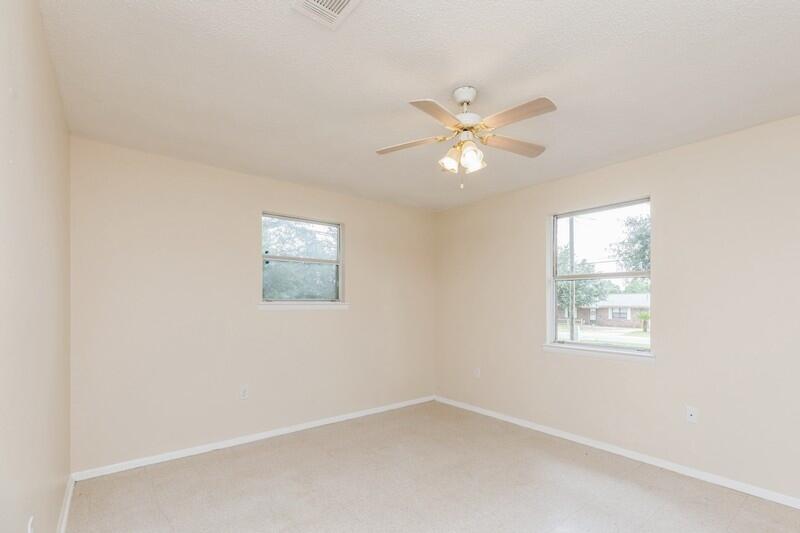 3369 Auburn Road Crestview, FL 32539 - Photo 18 of 33 an empty room with windows and fan