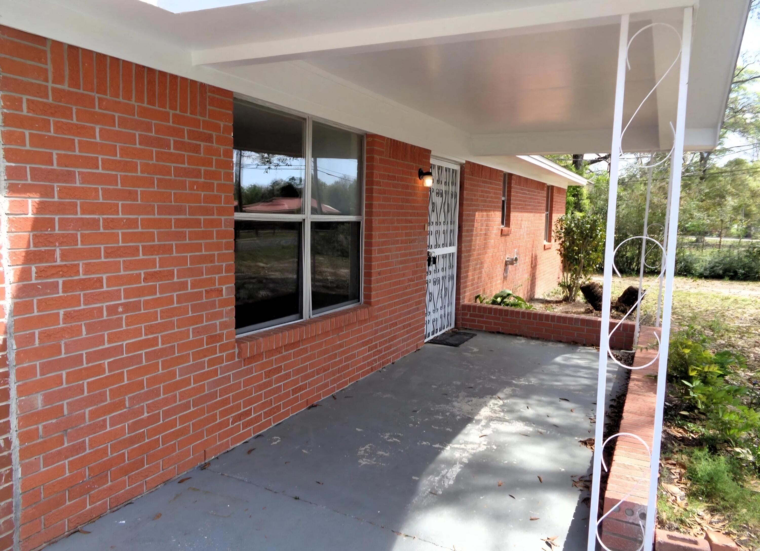 3369 Auburn Road Crestview, FL 32539 - Photo 2 of 33 a view of house with backyard and porch