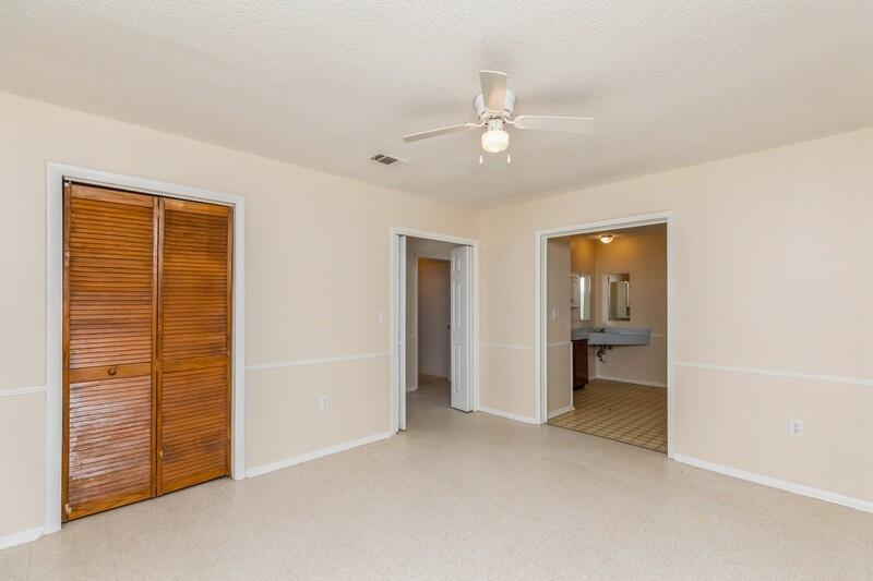 3369 Auburn Road Crestview, FL 32539 - Photo 23 of 33 an empty room with windows and closet
