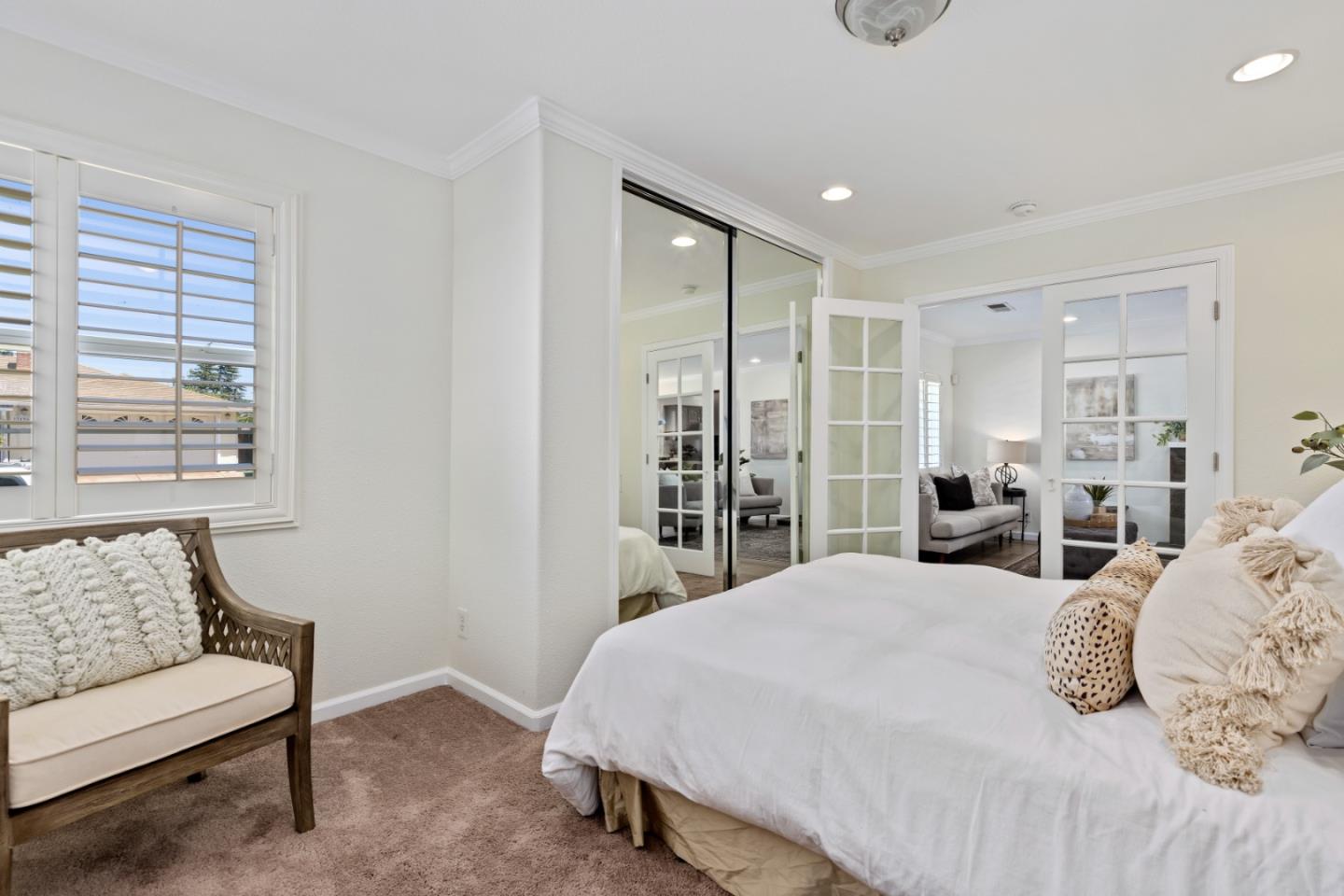 23131 Nevada Road Hayward, CA 94541 - Photo 12 of 28 a spacious bedroom with a bed a couch and a window