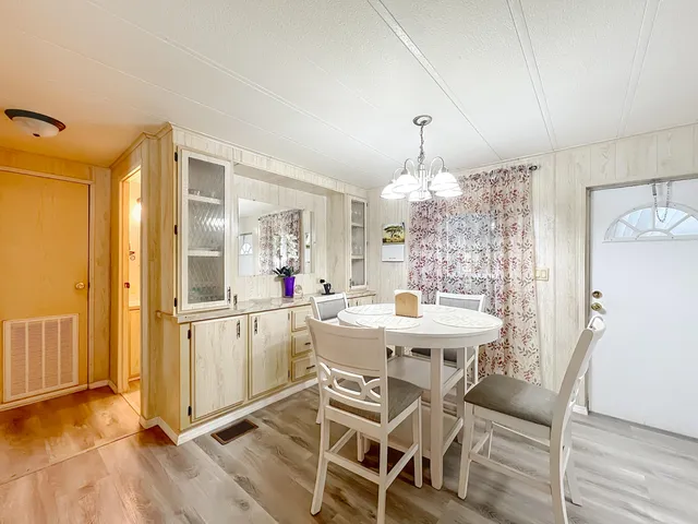 a dining room with furniture window and wooden floor