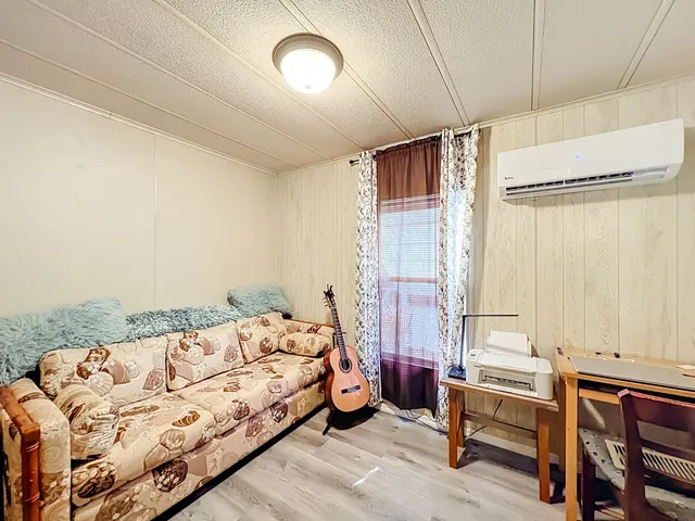 a bedroom with furniture and a large mirror