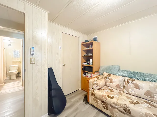 a bed room with a bed and a television