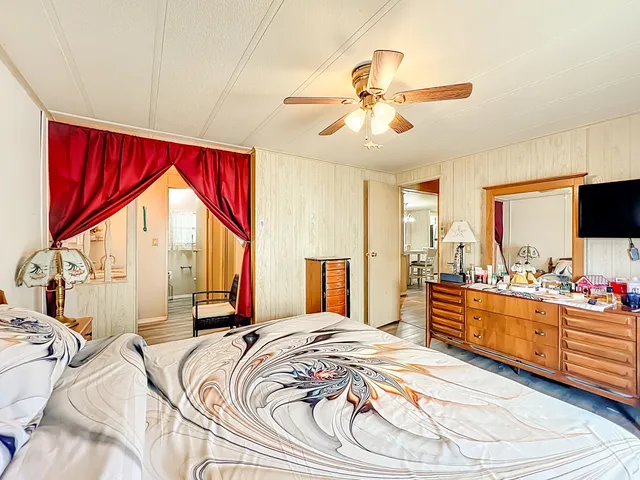 a en suite bathroom with a granite countertop sink and a mirror