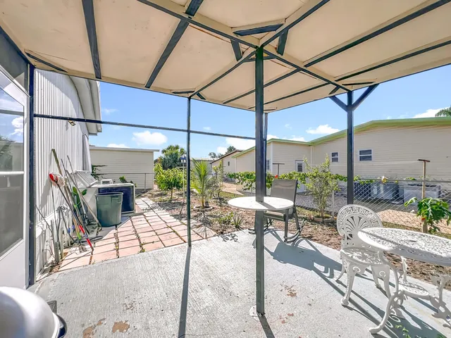 a bedroom with furniture and a large window