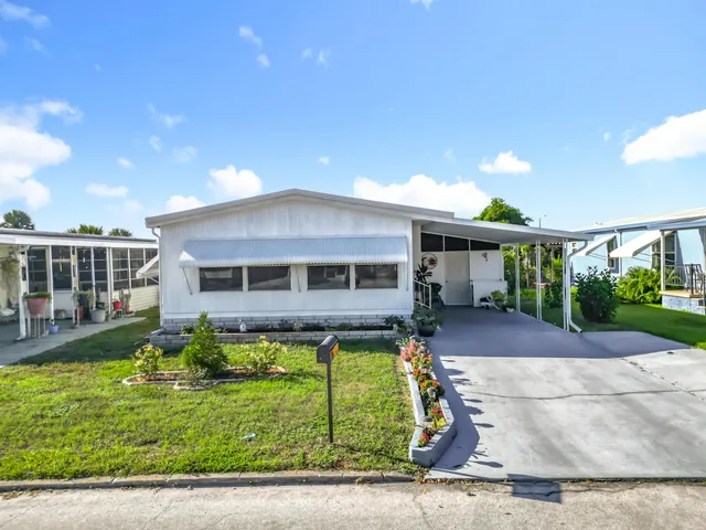 a view of a house with swimming pool and sitting area
