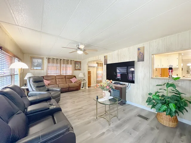 a kitchen with granite countertop a sink a stove and cabinets