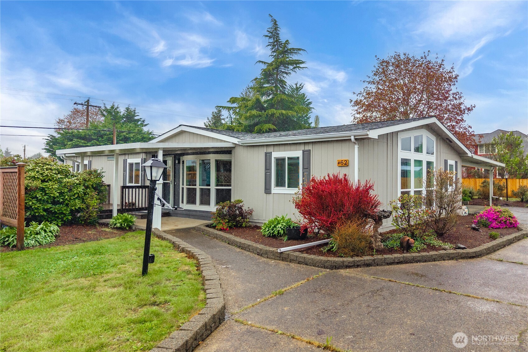 836 Harman Way South, Unit 62 Orting, WA 98360 - Photo 2 of 40 a front view of a house with yard